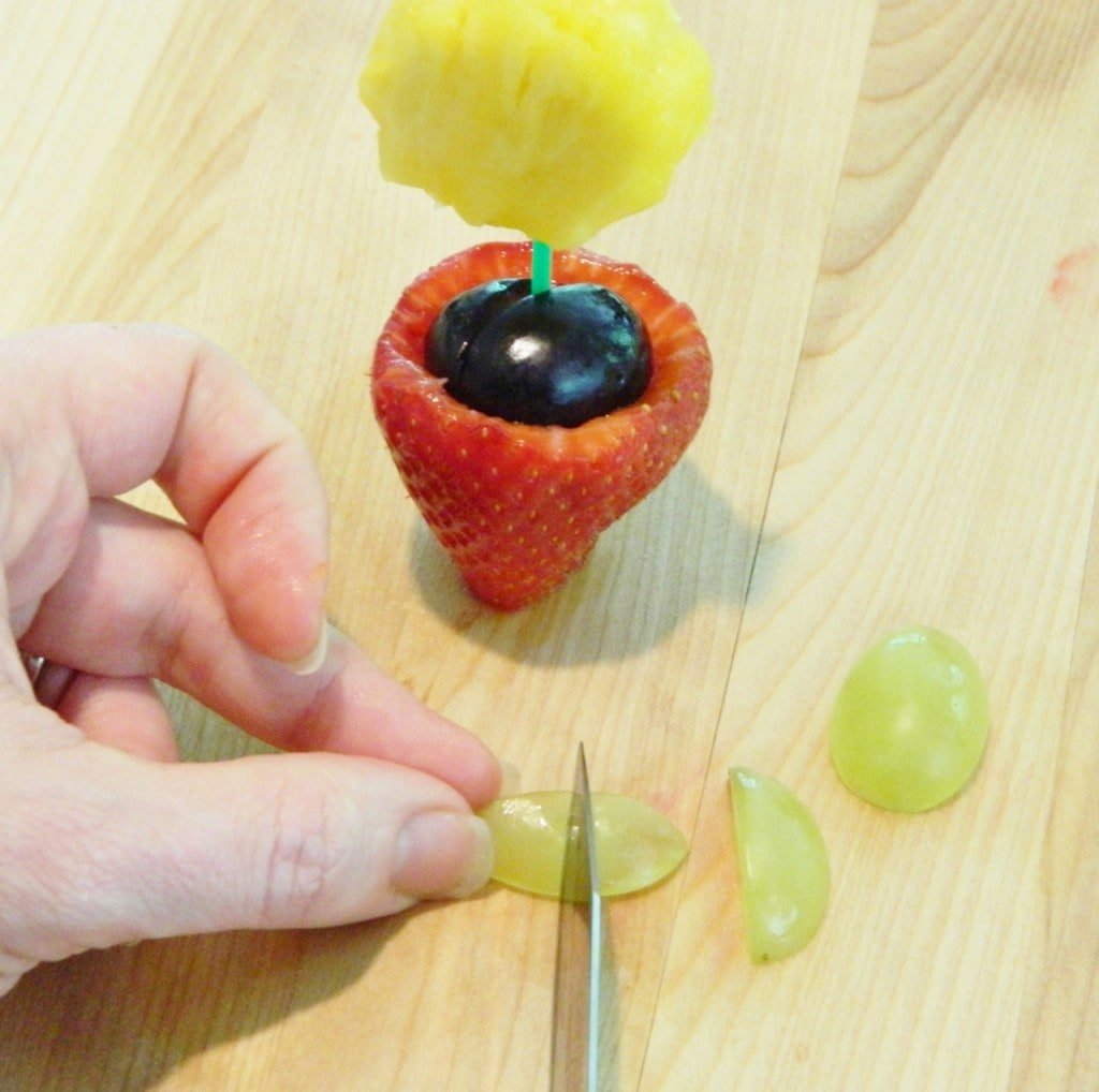 Cut a green grape in half & then cut that half into another half