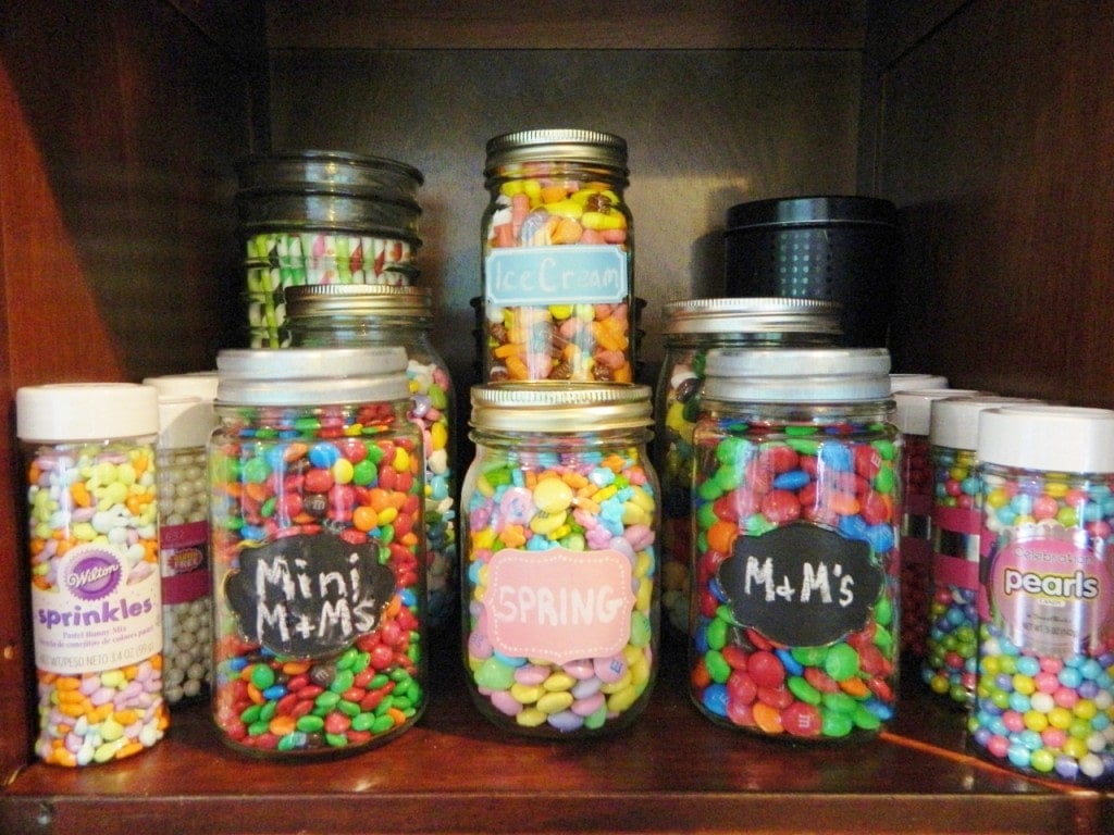 We have different candy, sprinkles, decorative straws, & sticks in the top of the cabinet. We use mason jars with the labels written in chalk for lots of them