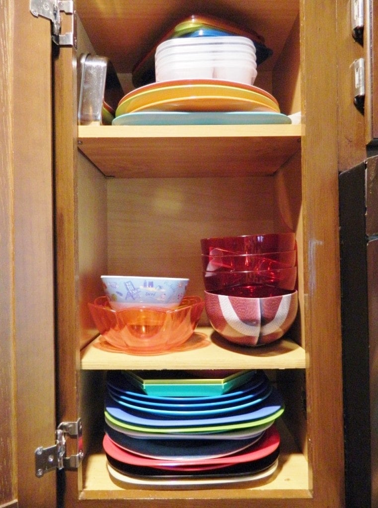 We keep our colored plates, bowls, & bento lunch containers in this cabinet in our kitchen