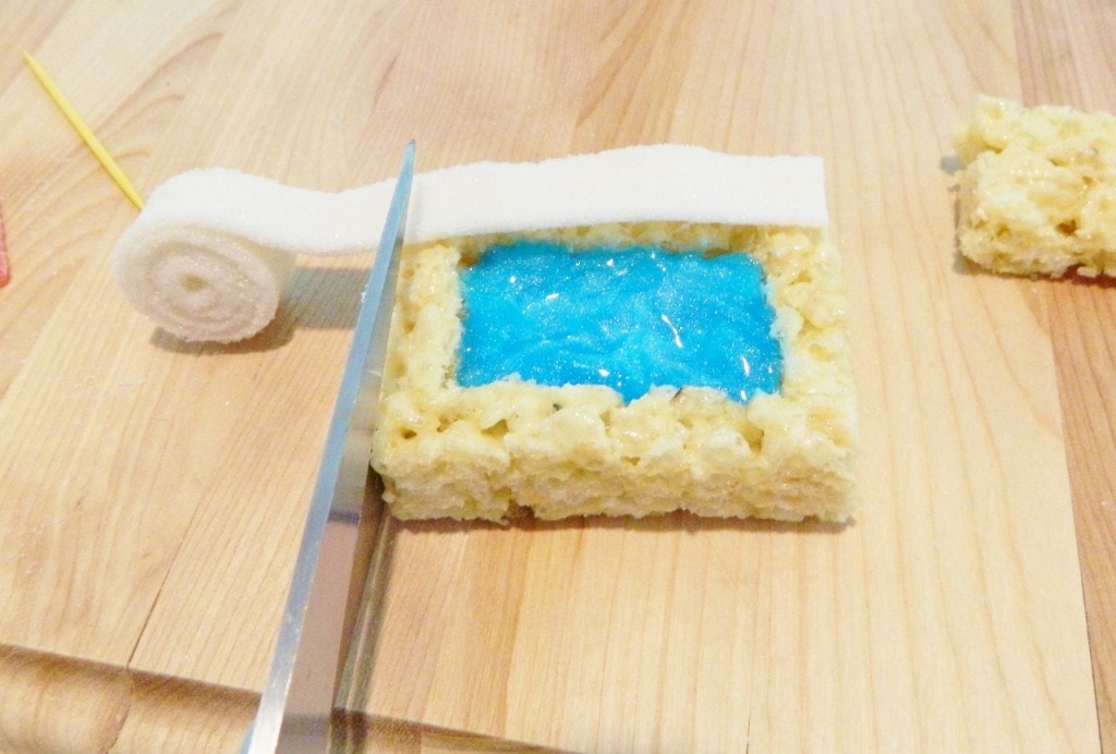 Cut the white candy strips to fit on top using kitchen scissors