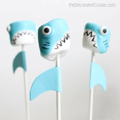 Three marshmallow shark pops with a plain white background
