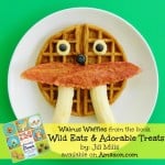 A waffle that has been decorated with breakfast food to look like a walrus