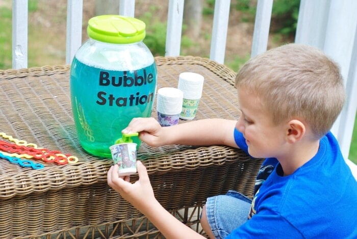 kid adding bubbles to a cup