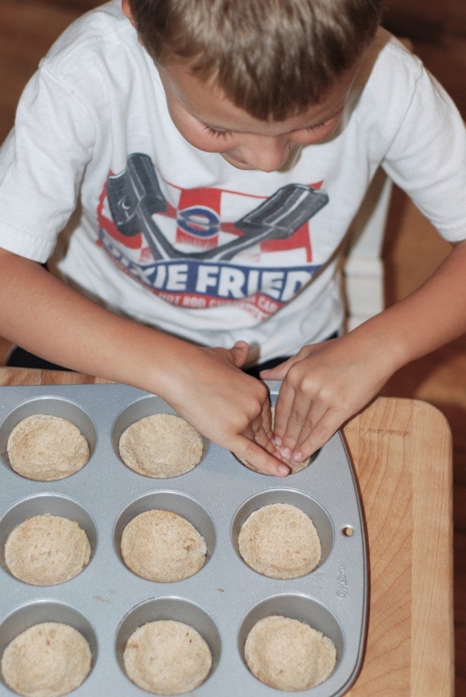 Pressing the bread in the muffin tins