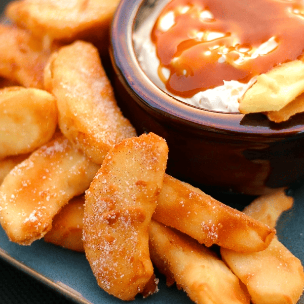 A blue platter of Apple Fries with a dipping cup of Caramel Cream Dip in the center.