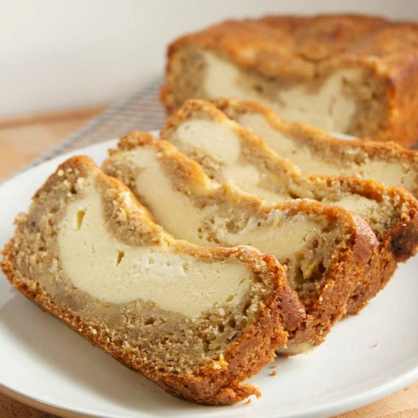 Slices of Cream Cheese Banana Bread fanned across a white plate.