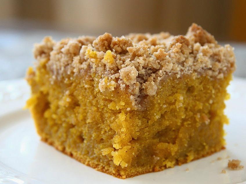 Close up shot of Pumpkin Crumb Coffee Cake on a white saucer.
