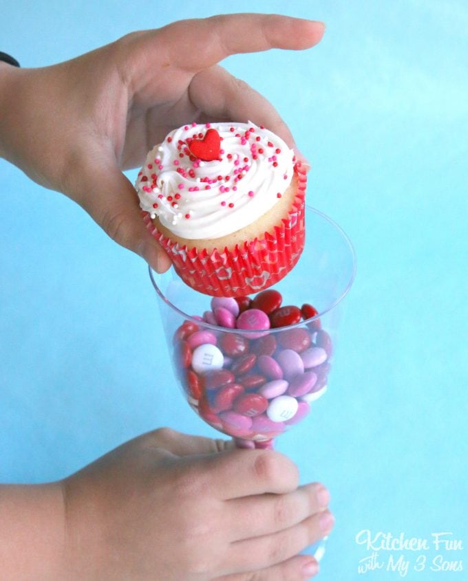 Valentine Cupcakes served in Plastic Wine Glasses filled with Candy! Such a fun idea for the Kids for Valentine's Day!