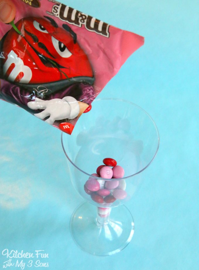Pouring m&m's in a plastic wine glass