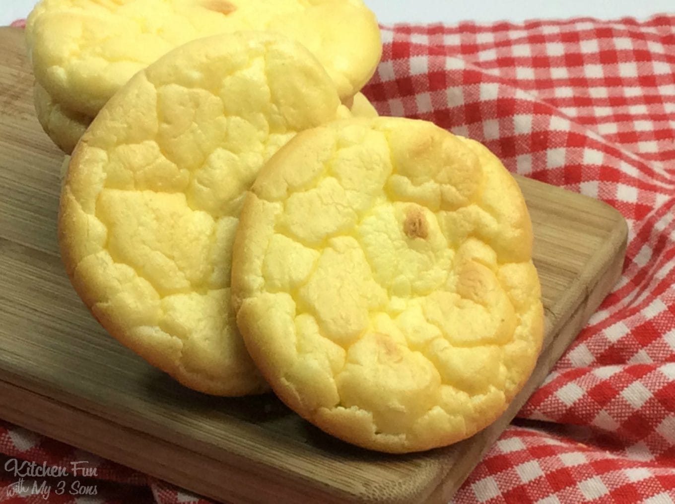 baked cloud bread rounds on a wooden cutting board