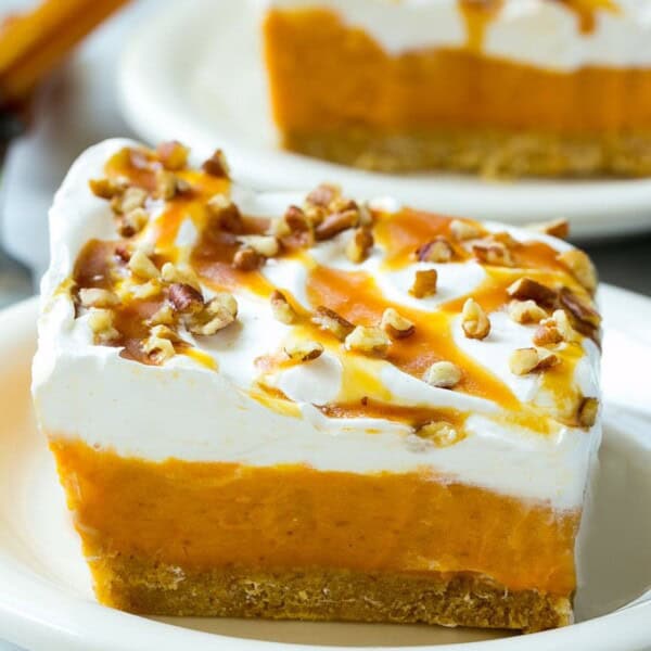 This easy no-bake pumpkin lush is layers of graham cracker crust, pumpkin pudding and whipped topping, all topped with caramel and pecans. The ultimate fall dessert!
