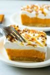 This easy no-bake pumpkin lush is layers of graham cracker crust, pumpkin pudding and whipped topping, all topped with caramel and pecans. The ultimate fall dessert!