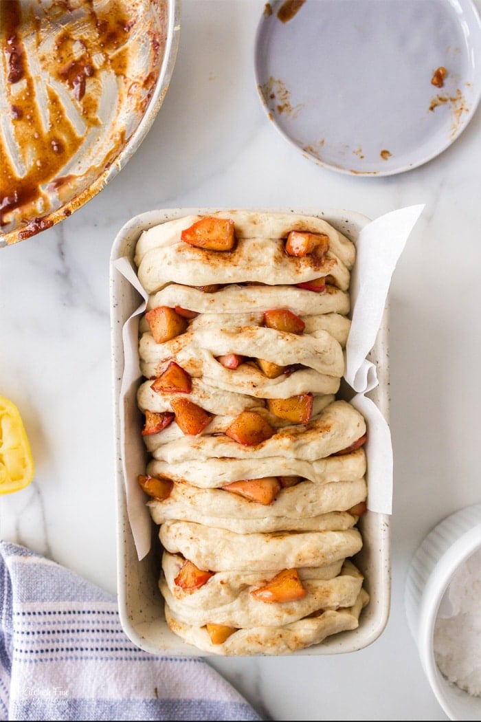 Apple Pull Apart Bread is the perfect recipe to make on an Autumn day after a day of apple picking. Flaky biscuits with fresh apples coated in sugar and spices all topped with a delicious glaze.