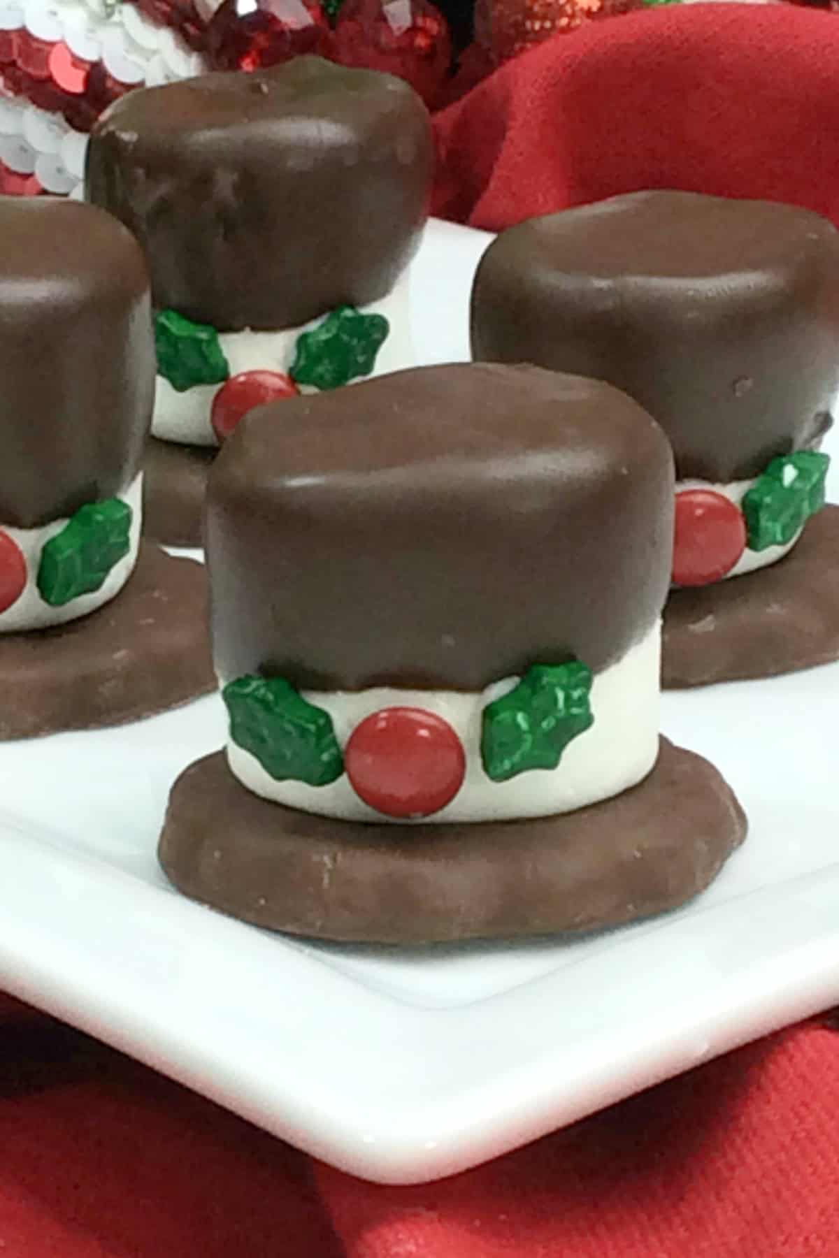 These Snowman Hat Cookies are such a fun Christmas treat to make with or for kids using just 5-ingredients including Grasshopper cookies, chocolate and assorted candies! Snowman Hat Cookies on a white platter