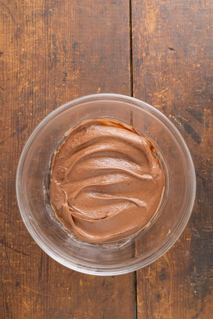 Cream cheese mixed with brownie batter in a bowl