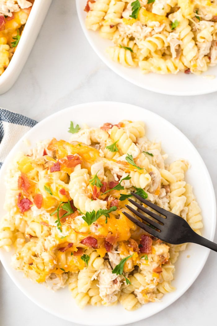 A black fork on a plate of chicken bacon ranch pasta