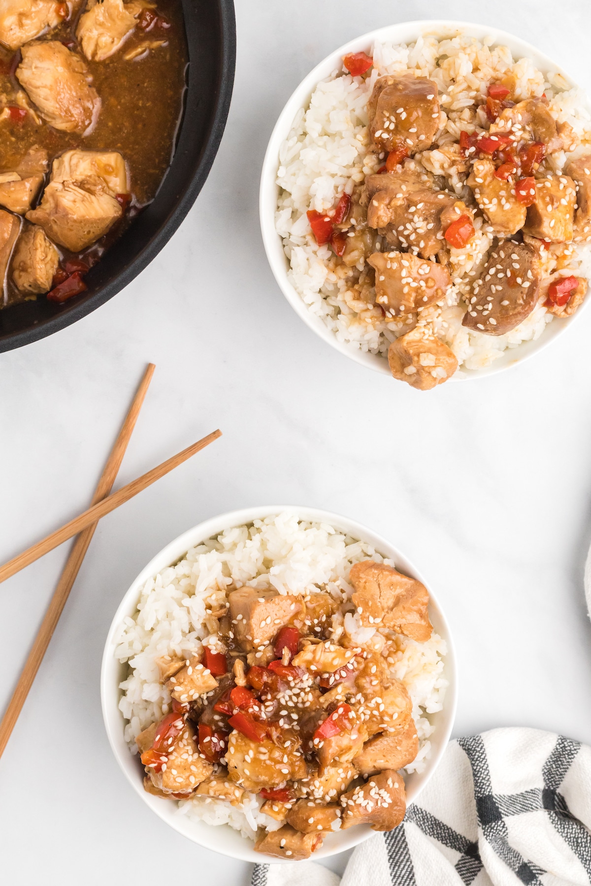 Overhead view of two bowls of teriyaki chicken served over rice