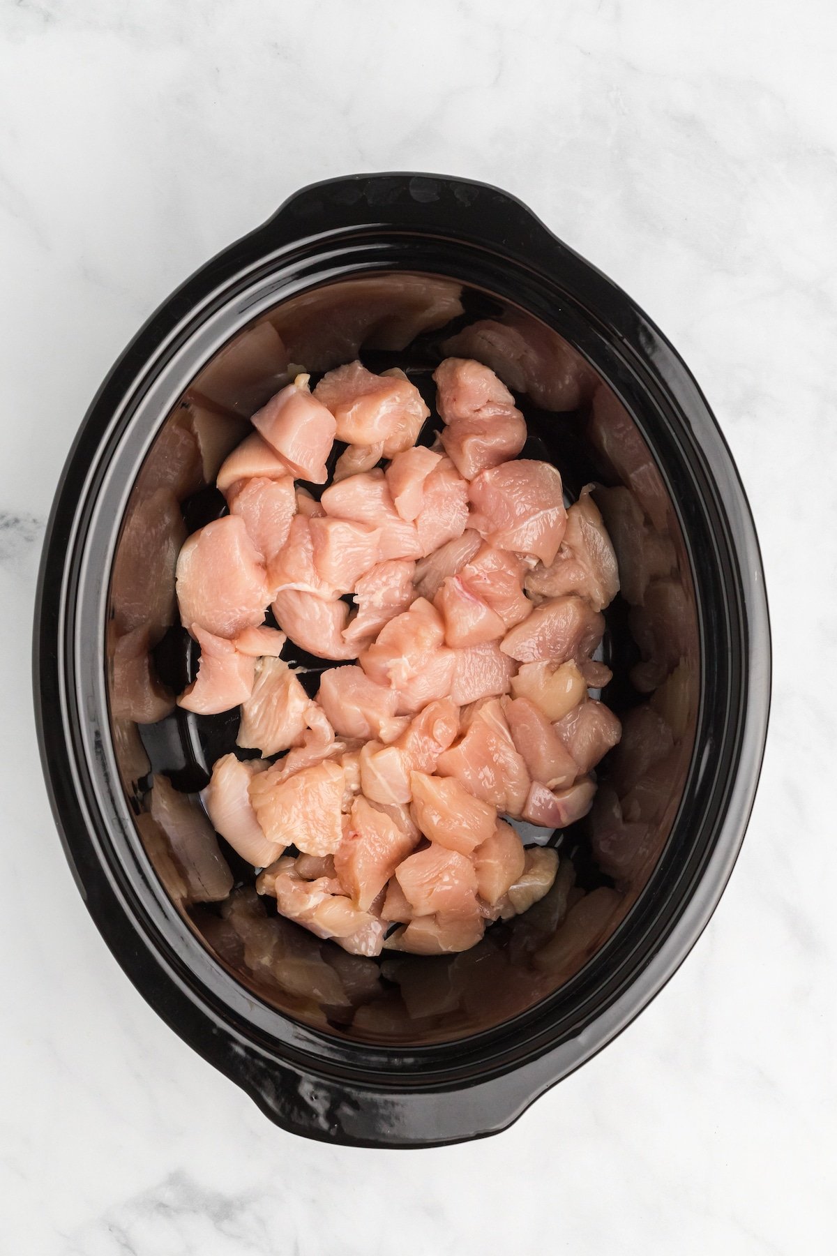 Chunks of chicken breast in the crockpot