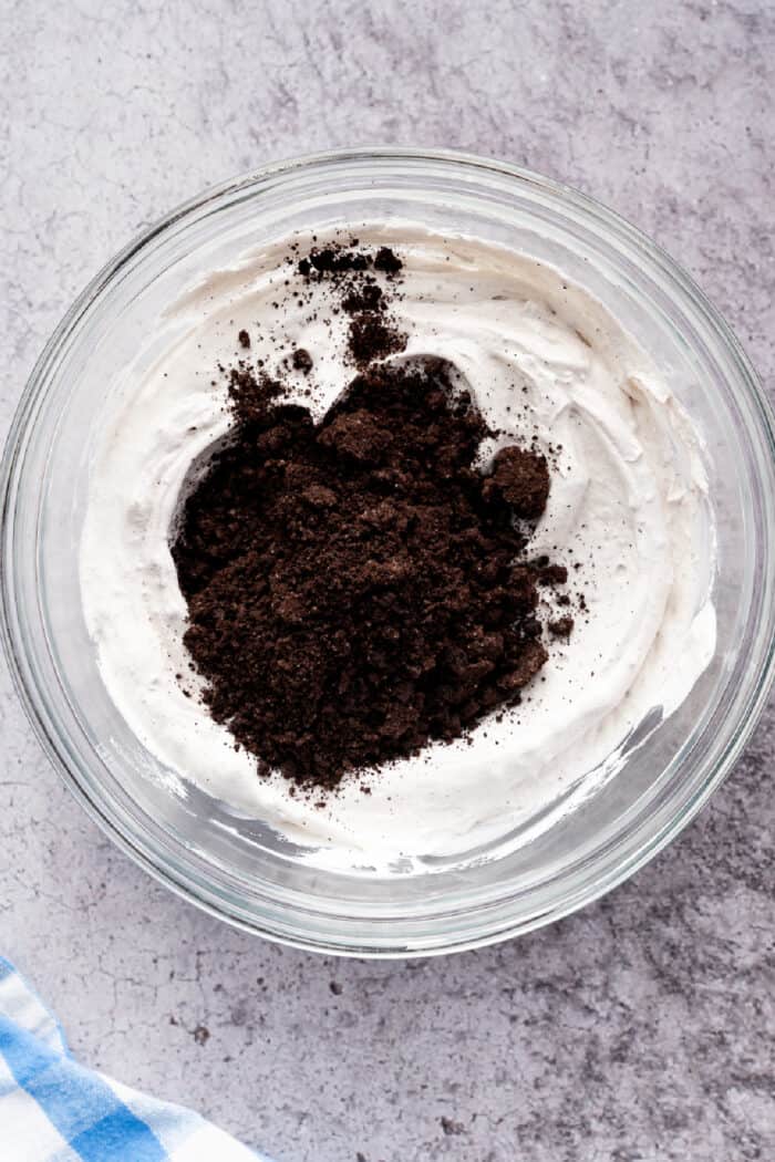 crushed Oreos on top of pudding ready to be mixed