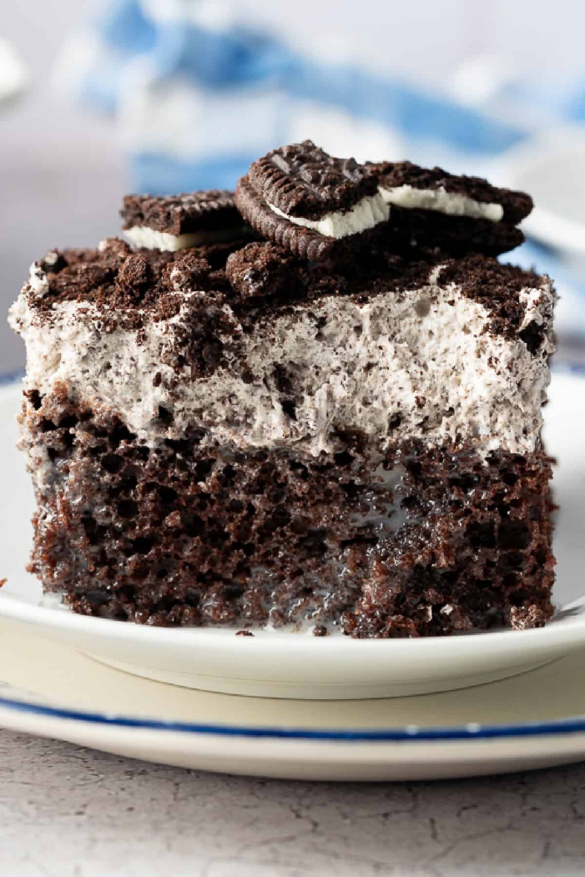 Oreo Poke Cake slice on a plate
