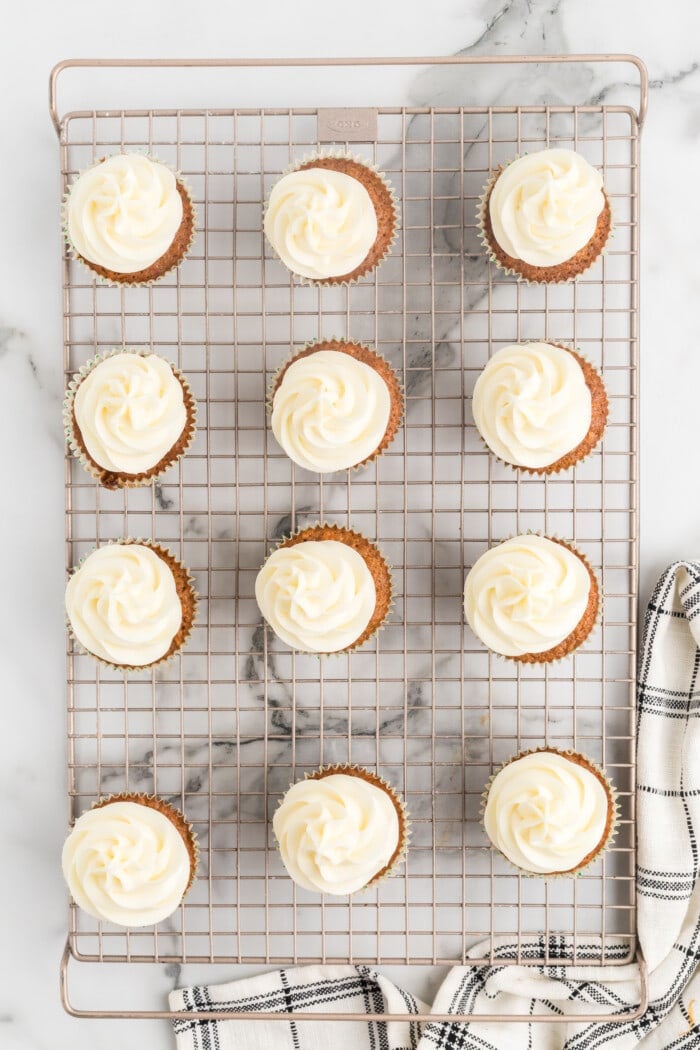Frosting the Carrot Cake Cupcakes.