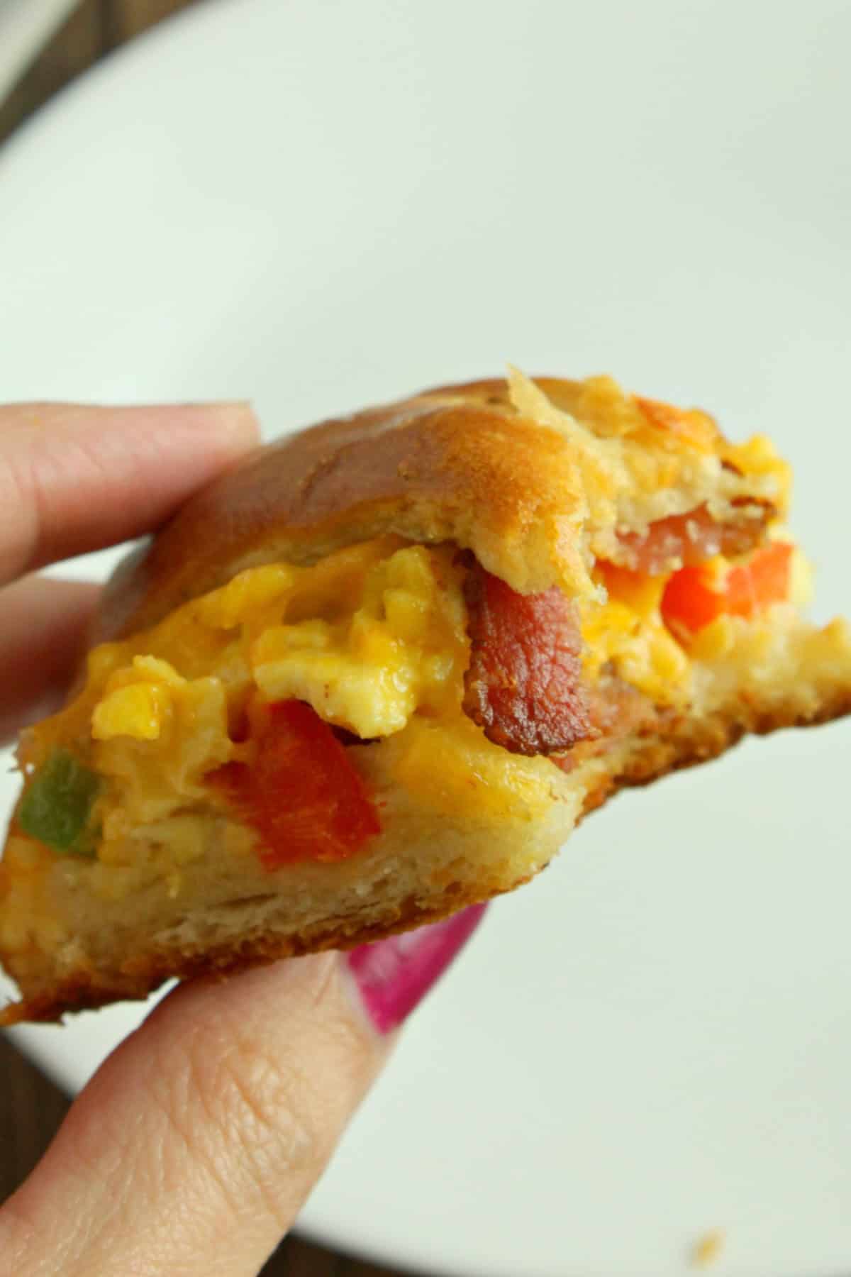 holding a slice of a Breakfast Crescent Ring