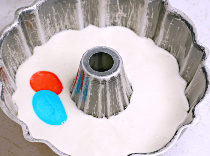 adding colored batter to the bundt pan
