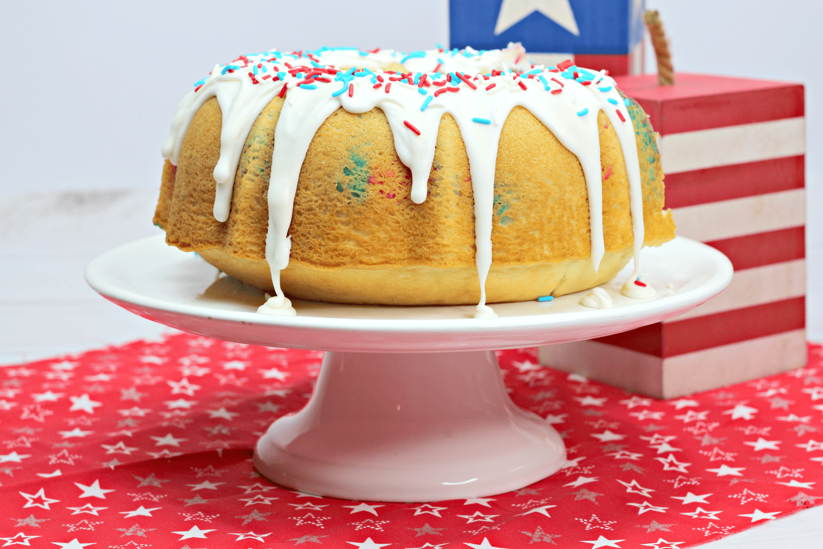 red white and blue cake on a white cake stand