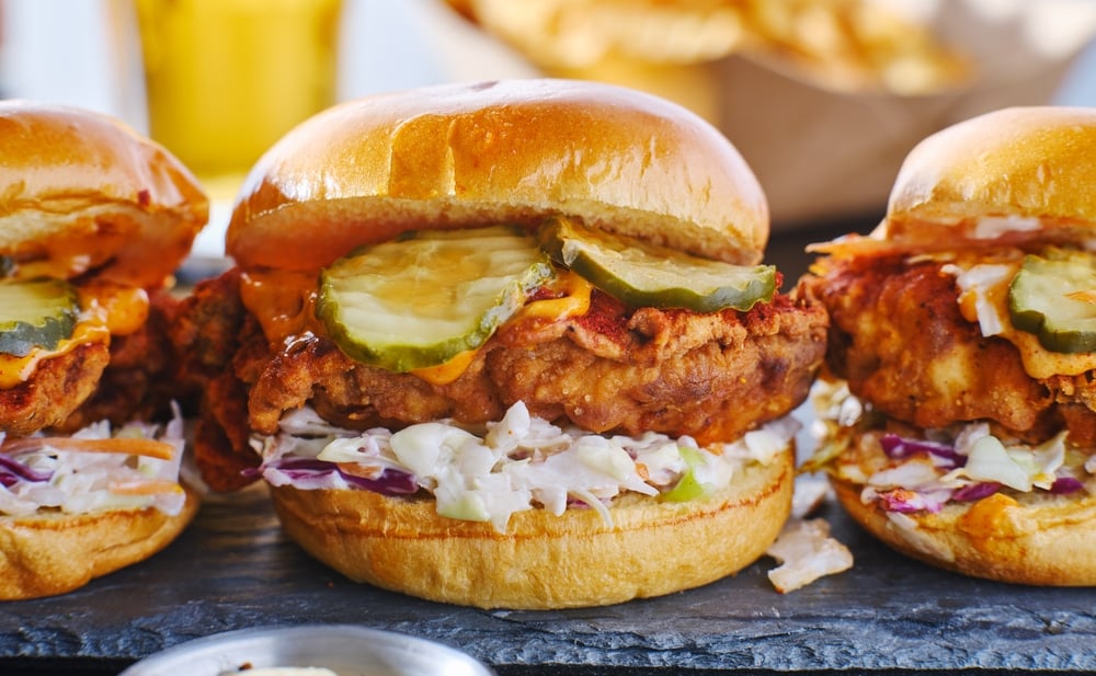 Three Nashville Fried Chicken Sandwiches on a slate tray