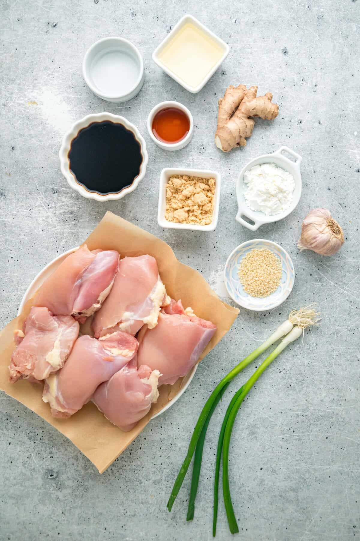 Tender, juicy chicken is baked in a sweet and savory glaze in this Baked Teriyaki Chicken Thighs recipe. Quick & easy! Overhead view of the ingredients needed to make teriyaki chicken thighs