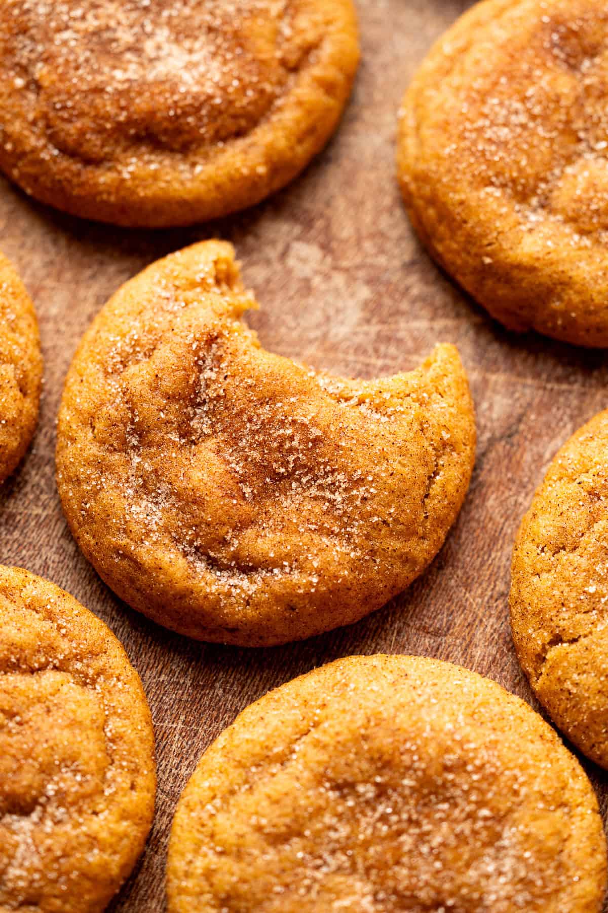 a bite taken from a pumpkin snickerdoodle cookie