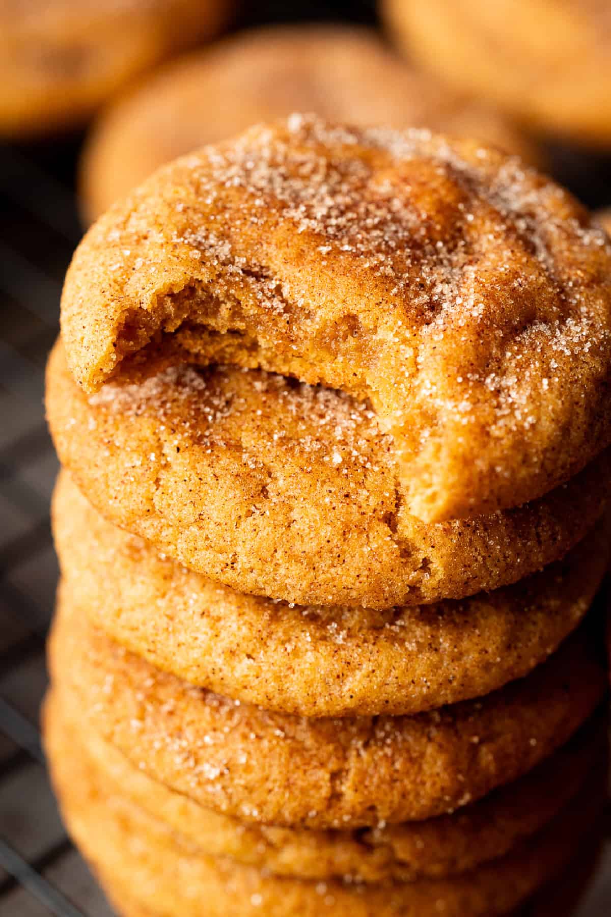 Soft, chewy, and full of pumpkin flavor, these Pumpkin Snickerdoodles are the perfect cookies for fall, with pumpkin puree & pumpkin spice. pumpkin snickerdoodles stacked with a bite taken out of the top cookie