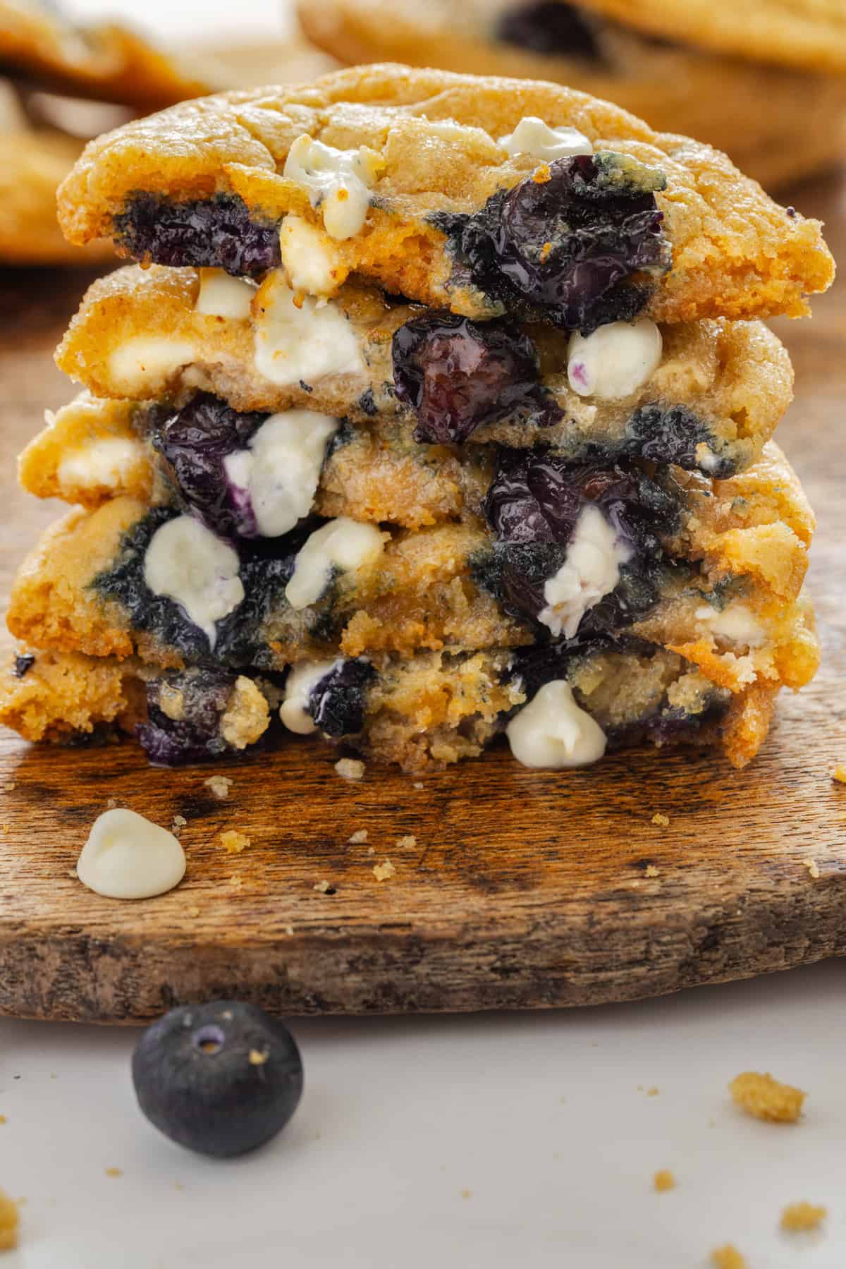 Halves of blueberry cookies stacked on each other to show the inside
