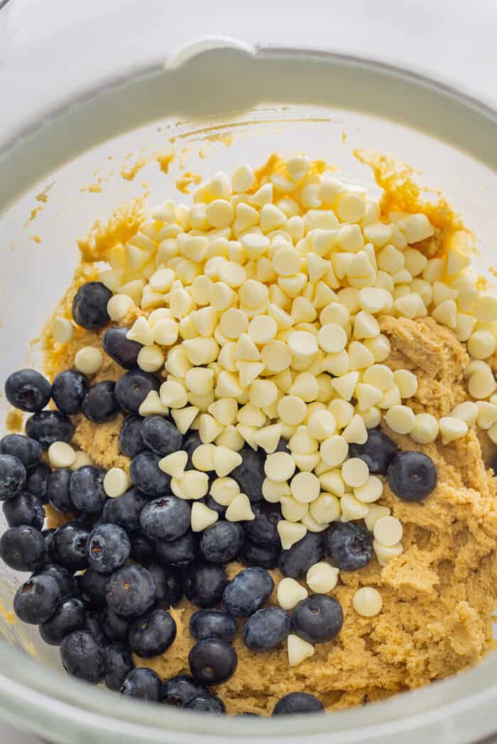 Blueberries and white chocolate chips added to cookie dough