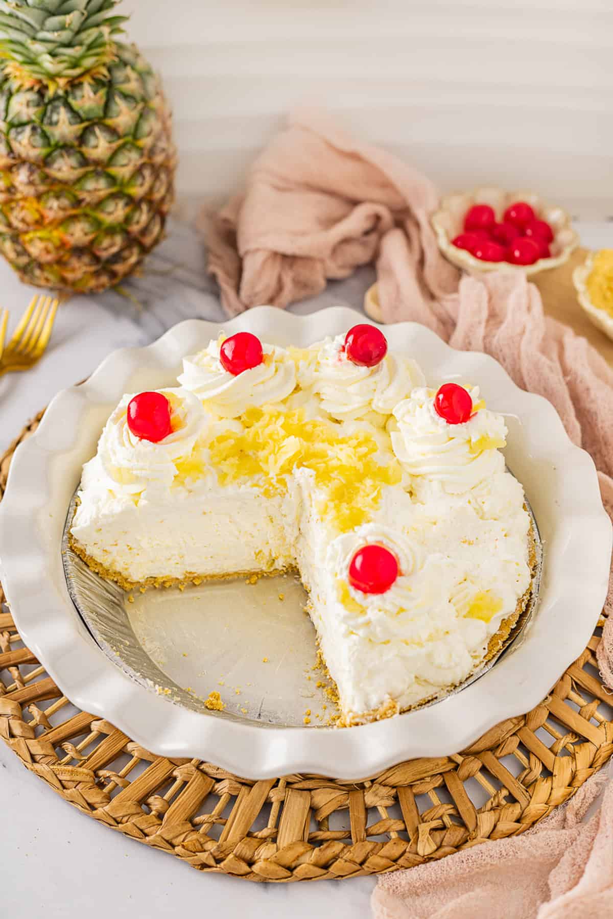 A no bake pineapple pie with one slice missing