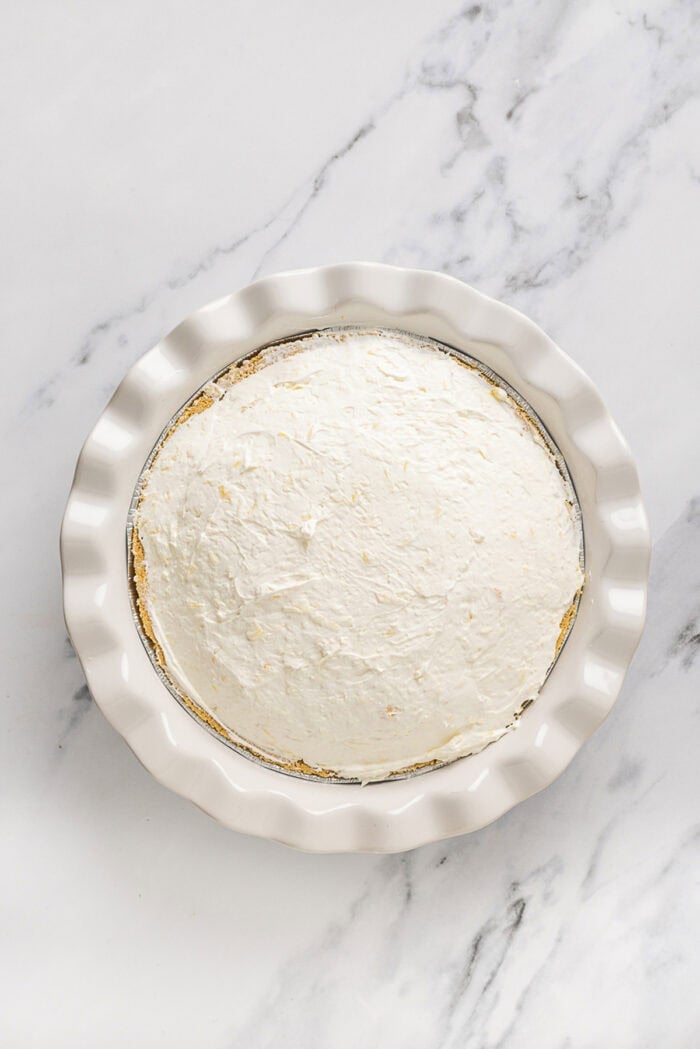 Overhead view of pineapple pie in a white pie plate