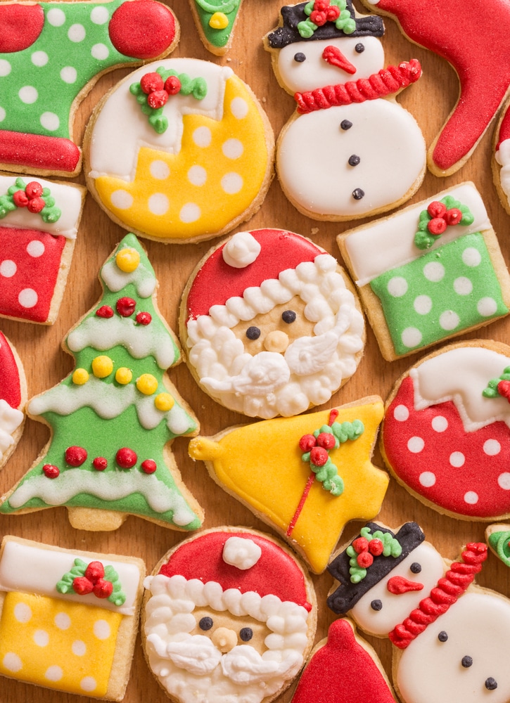 Decorated Christmas sugar cookies that look like santa, snowmen, trees, bells and presents.