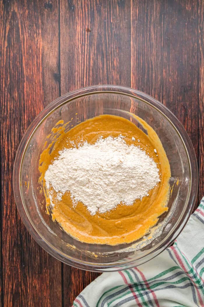 Warmly spiced, moist bread is topped with tangy cream cheese frosting in this Gingerbread Loaf recipe, inspired by Starbucks. Combining wet and dry loaf ingredients in a bowl