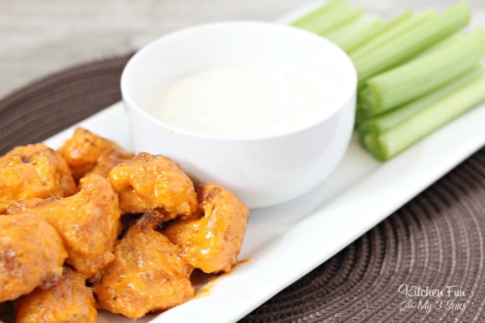 "skinny" buffalo wings on a platter with celery and dressing