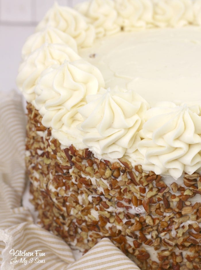 This Carrot Cake recipe is layered with moist cake, cream cheese frosting and cheesecake. This is the best way to make a carrot cake!