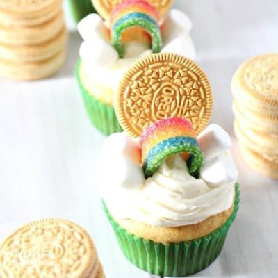 These Easy St. Patrick's Day Cupcakes are the cutest things ever. Add a golden Oreo, marshmallows and rainbow candy to make a simple and yummy holiday treat.