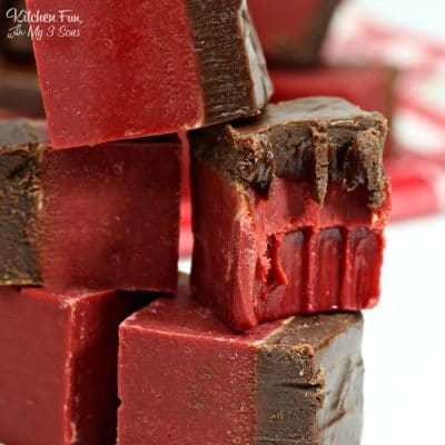 Close up of squares of red velvet chocolate fudge stacked on top of one another.