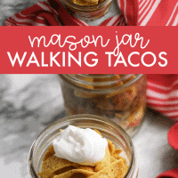 Walking tacos in a jar topped with sour cream.
