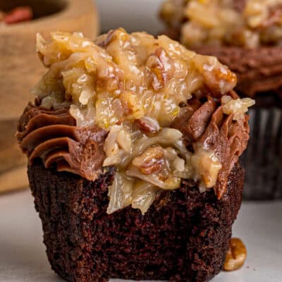 A German chocolate cupcake with a bite missing to show the inside