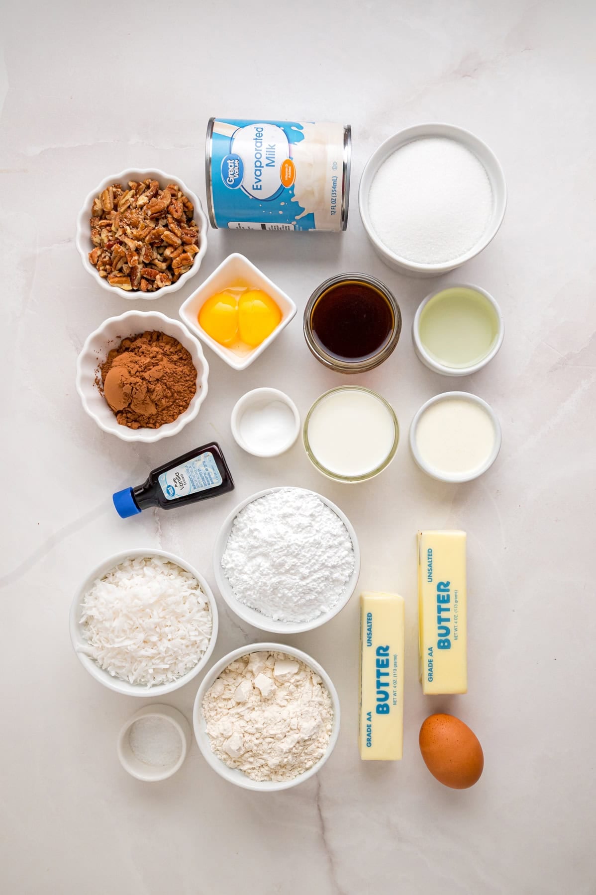 Chocolate cupcakes are filled with a sweet coconut pecan mixture and topped with chocolate buttercream in these German Chocolate Cupcakes. Overhead view of ingredients needed to make German chocolate cupcakes