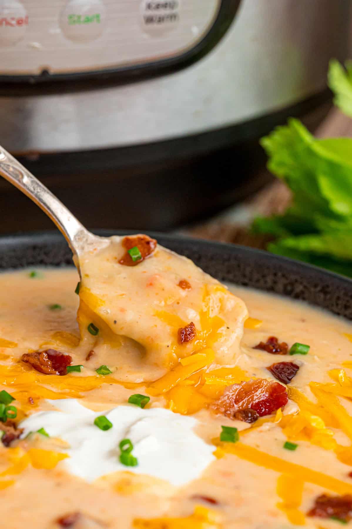 With a creamy base and tender chunks of potato in every bite, this Instant Pot Potato Soup comes together in just 45 minutes. A spoon in a bowl of Instant Pot potato soup