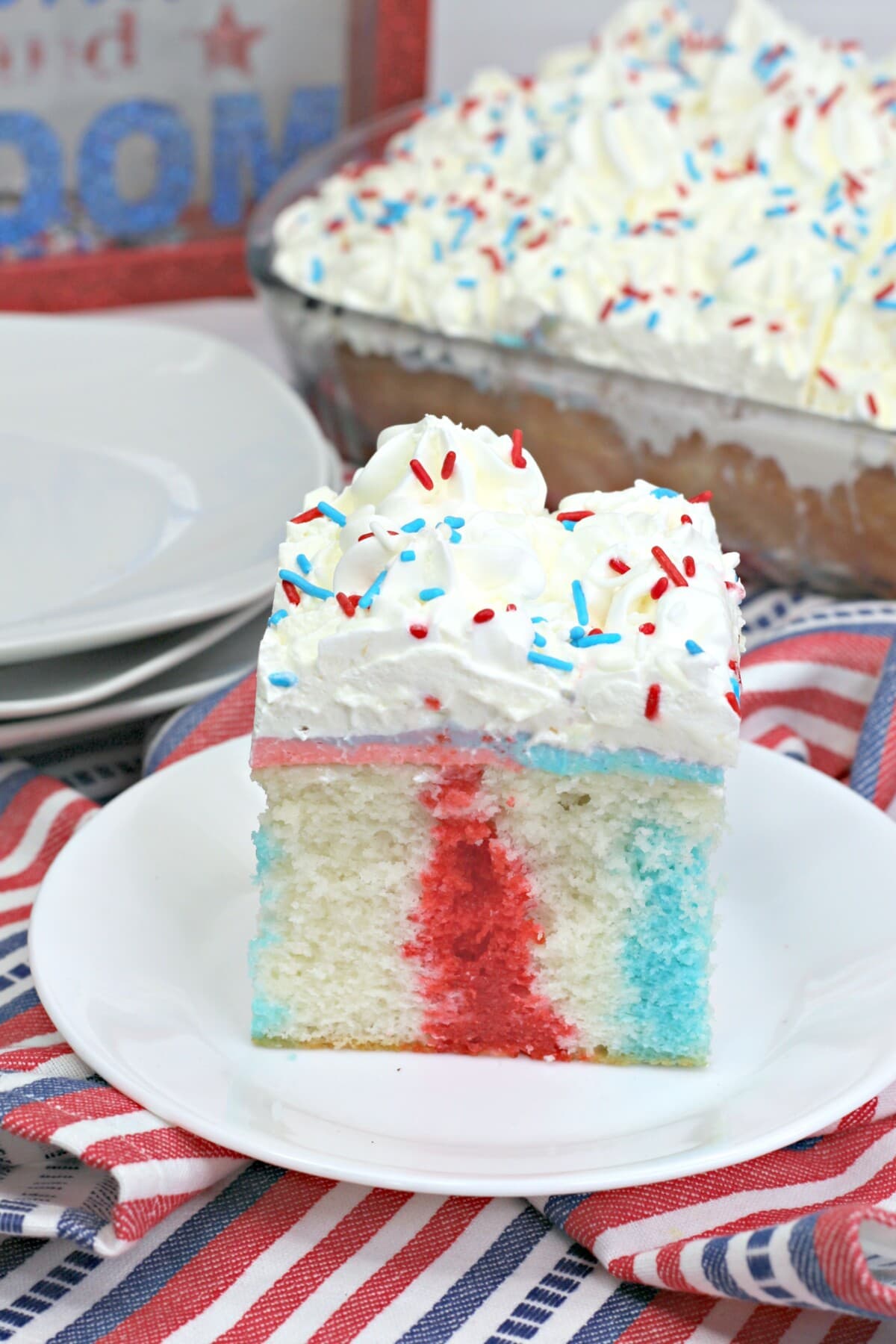 a slice of Red White and Blue Poke Cake on a plate