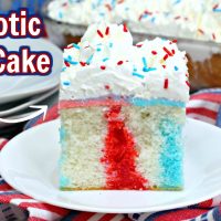 Patriotic Poke Cake topped with red and blue Jello, cool whip, and sprinkles.