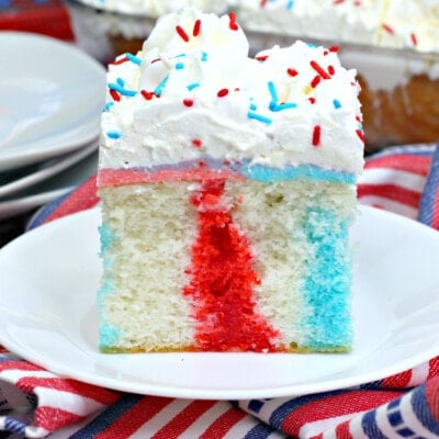 a slice of Red White and Blue Poke Cake on a plate feature