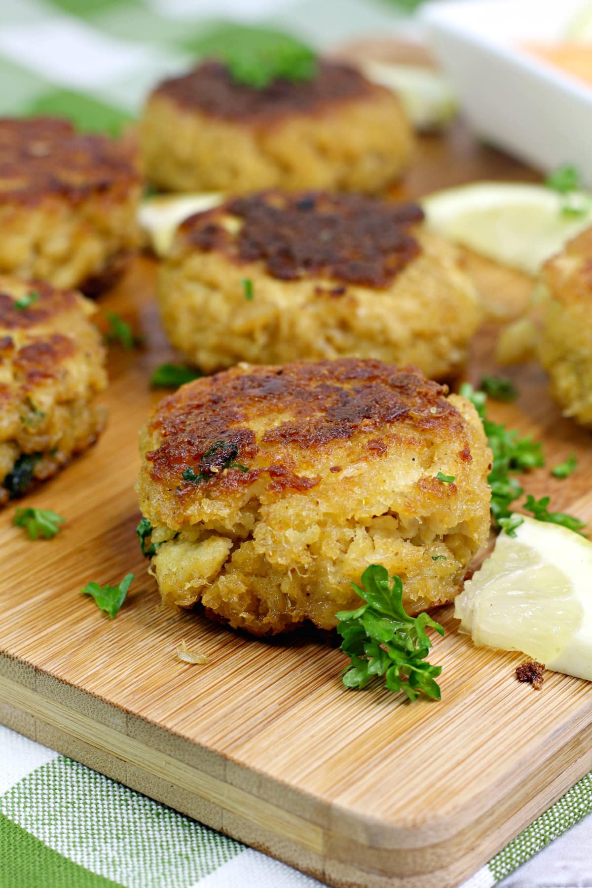 Homemade crab cakes on a wooden cutting board